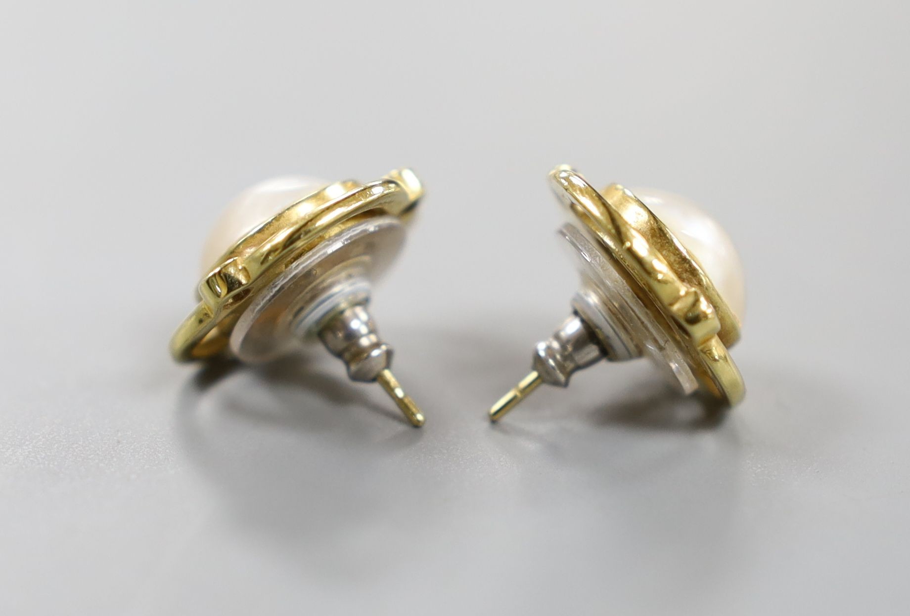 A pair of 750 yellow metal, mabe pearl and diamond chip set earrings, 16mm, gross weight 7 grams